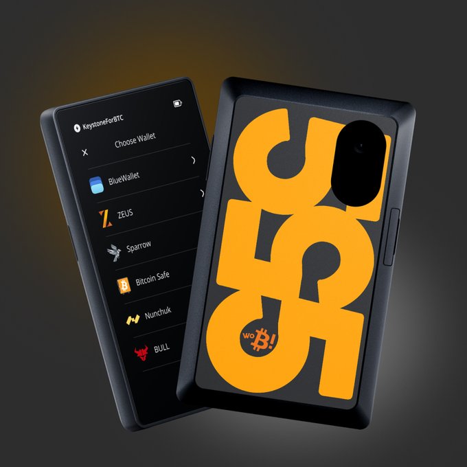 Product render of a KeystoneForc hardware wallet with an orange 'CSG' case, displaying a 'Choose Wallet' menu showing options like BlueWallet, ZEUS, Sparrow, Bitcoin Safe, Nunchuk, and BULL.