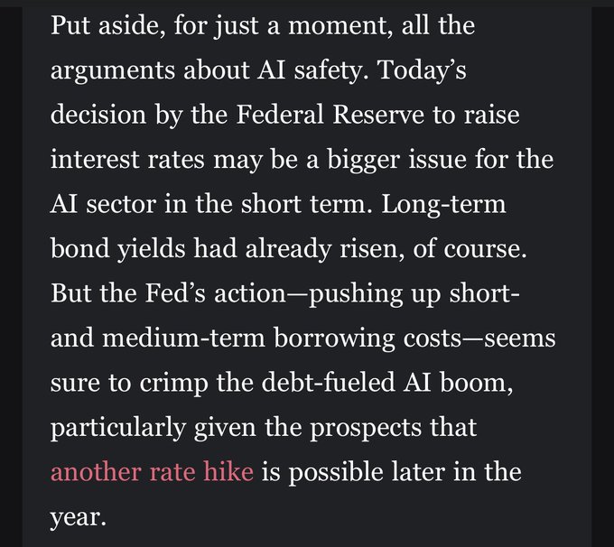A screenshot of text discussing the Federal Reserve's interest rate decision and its impact on the AI sector, reading: 'Put aside, for just a moment, all the arguments about AI safety. Today's decision by the Federal Reserve to raise interest rates may be a bigger issue for the AI sector in the short term...' with the phrase 'another rate hike' highlighted in red.