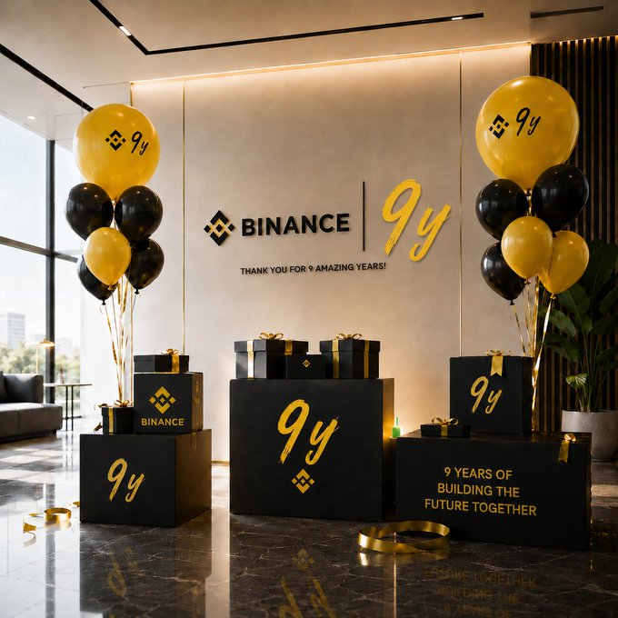 Binance's 9th birthday celebration display features branded black and yellow balloons, gift boxes marked "9Y," and signage reading "BINANCE | 9Y - THANK YOU FOR 9 AMAZING YEARS!" and "9 YEARS OF BUILDING THE FUTURE TOGETHER," corresponding to the "Birthday Balloon Vault" puzzle where users are searching for 2 hidden green candles.