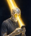 A dark, stylized digital painting of an ominous skull-faced figure engulfed in bright yellow and orange flames, set against a black background.