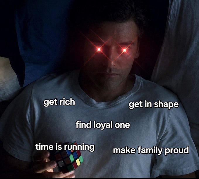 The image shows a man lying in bed at night with glowing red eyes, holding a Rubik's cube, with text overlays listing his racing thoughts: "get rich," "get in shape," "find loyal one," "time is running," and "make family proud"—humorously depicting how crypto enthusiasts lie awake consumed by their ambitious goals and anxieties while the rest of the world sleeps peacefully.