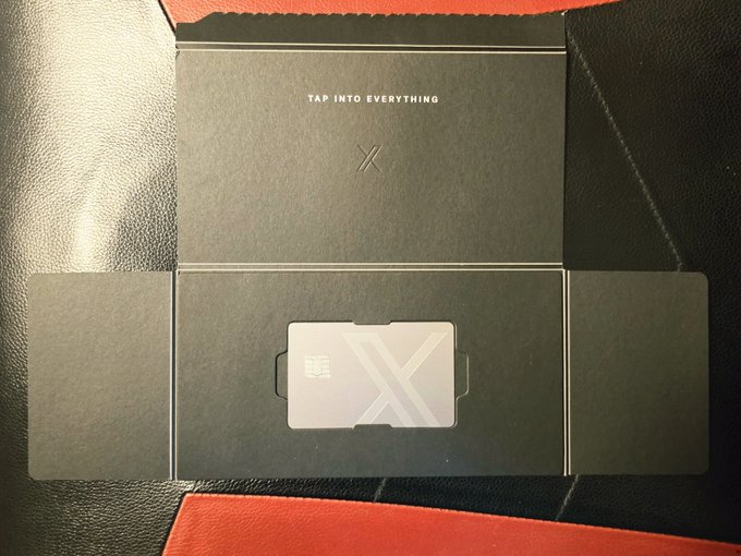 The image shows an unboxed X Money card resting in its sleek black packaging, which displays the tagline "TAP INTO EVERYTHING" and an "X" logo, matching the user's excited post about receiving their new X Money card and unlocking a new era of financial access.