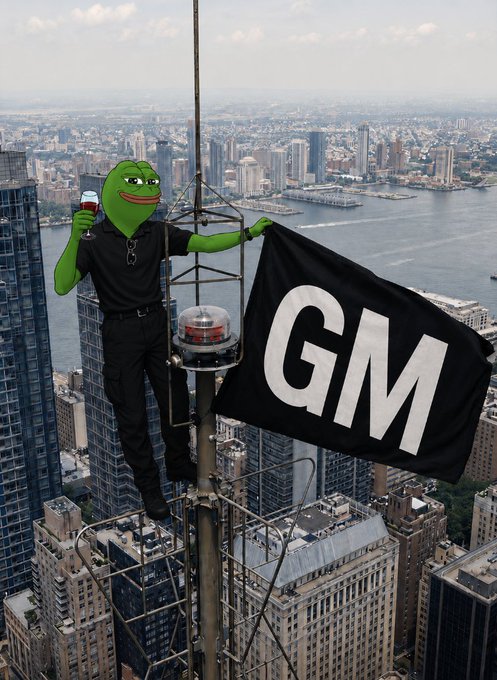 A composite image shows a green Pepe frog character in a black outfit holding wine, perched atop a New York City skyscraper antenna waving a black 'GM' flag.