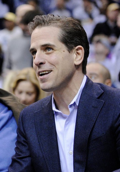 The image shows Hunter Biden, son of former U.S. President Joe Biden, smiling while wearing a navy blazer and light blue dress shirt at what appears to be a public event.

In relation to the post, the image accompanies a meme contrasting the value of "$LAPTOP" (referencing Hunter Biden's controversial laptop) versus "$TRUMP" memecoins, implying the post is making a political commentary about the relative market performance of these tokens despite the scandal surrounding the laptop.
