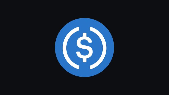 A blue circular logo featuring a white dollar sign flanked by parentheses—representing USDC, a stablecoin by Circle—symbolizes the minting of 500 million USDC tokens on the Solana blockchain.