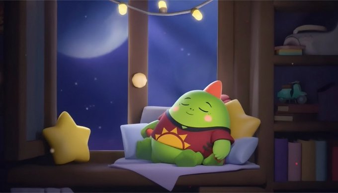 A green dinosaur plush character sleeps peacefully on a window seat by a starry night sky, surrounded by fairy lights, star pillows, and a cozy shelf of toys. The image ties to the post about Sleepagotchi by evoking restful sleep, the theme its on-device AI wellness agent is designed to monitor and improve.