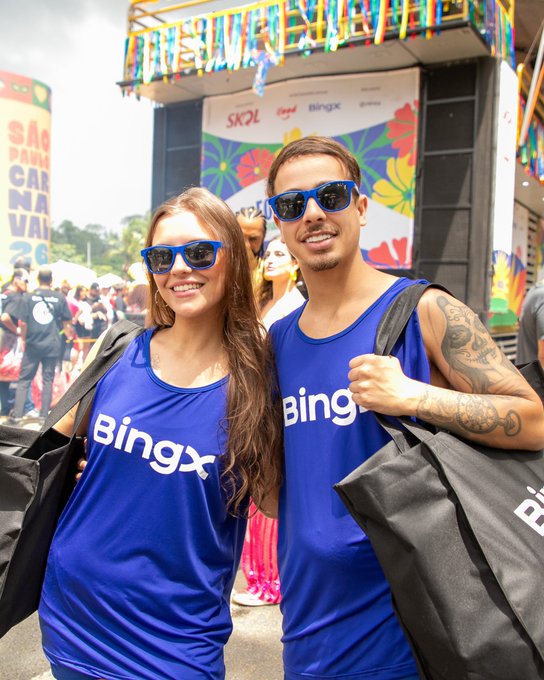 Two smiling people wearing matching blue "Bingx" tank tops and sunglasses pose at what appears to be the São Paulo Carnival 2026, standing in front of a colorful SKOL-sponsored stage. The image ties into the post's "#BingX" branding by showcasing enthusiastic community supporters, helping hype up the cryptocurrency brand for the week ahead.