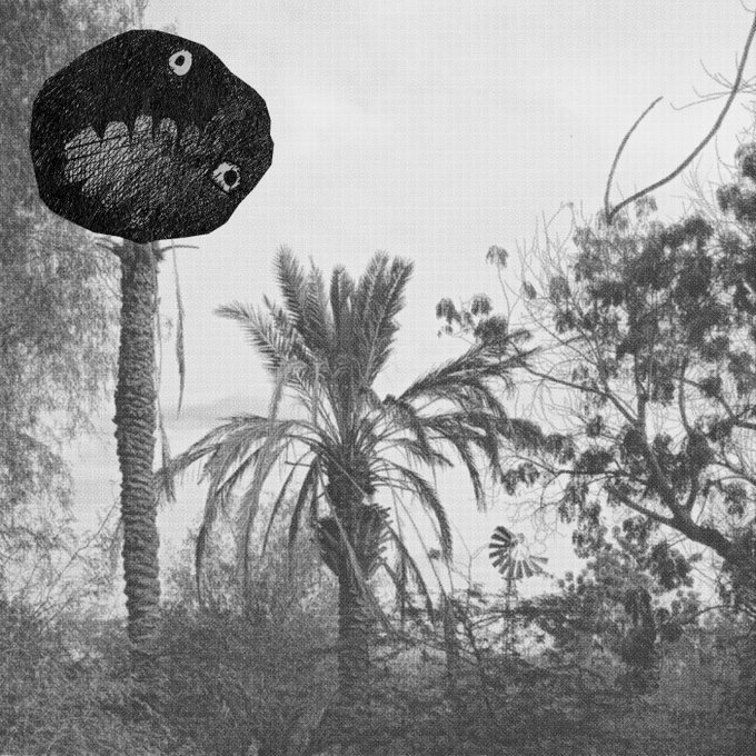 A grainy black-and-white photograph shows a rural landscape featuring palm trees, a windmill, and other foliage, dominated by a large, menacing black spherical figure perched atop a palm-like trunk with glowing eyes and a toothy grin—evoking the eerie, surreal atmosphere fitting for "A Catalogue of Silence," a 1/1 art piece exploring themes of absence and the uncanny.