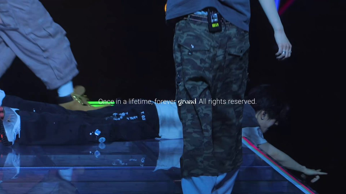 The image shows a group of people standing next to each other, with one person wearing camouflage pants and another holding a skateboard. The caption reads "260614 Look at the free Long Meggo, so free #XINLONG #鑫隆 #씬롱 #ALPHADRIVEONE #ALD1 #알디원". This image is related to a post on social media where someone has shared a picture of themselves with Long Meggo and their skateboard.