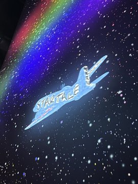 The image showcases an illuminated Startale logo featuring a stylized paper airplane soaring through a starry, cosmic background with vibrant rainbow lighting. This visually reinforces the post's message about the "Startale Aircraft" taking flight toward a stellar, blockchain-powered future with partners like Soneium, Astar Network, and Startale Group.