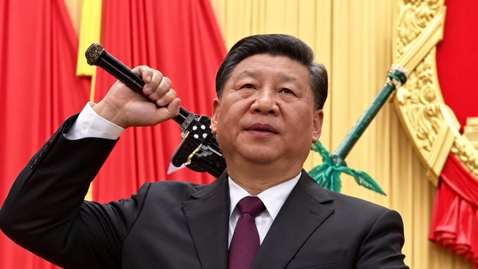 Xi Jinping is depicted raising the Sword of State in a formal ceremony, standing prominently in front of red drapes and gold decorations.