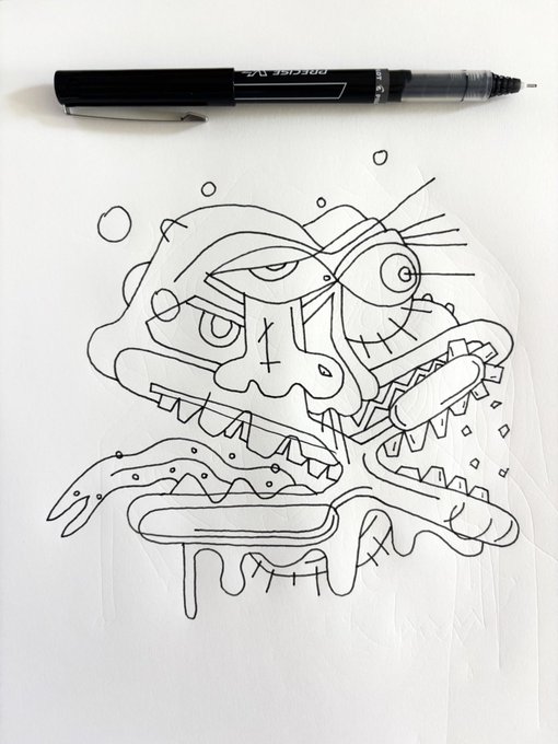 An abstract black ink line drawing of a strange creature with multiple eyes and teeth, drawn on paper with a black marker resting above it.