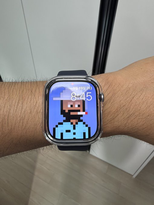 An Apple Watch on a wrist displays a pixel art watch face of a man with a cigar against a blue background, showing the time '8:45' and date '9월 19일'.