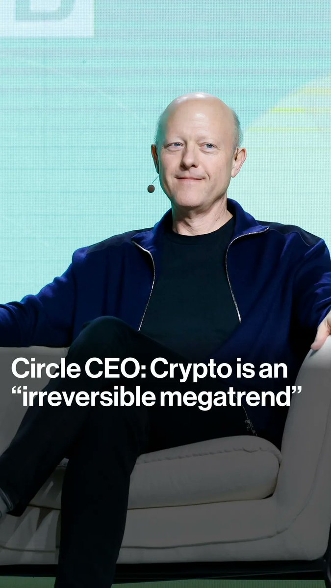 A bald man in a navy blue jacket sits on a stage chair with the caption 'Circle CEO: Crypto is an "irreversible megatrend"'.