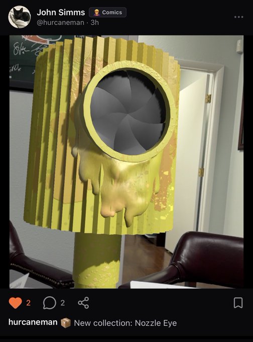 A screenshot of a tweet by John Simms (@hurcaneman) showing a yellow ribbed sculpture with a circular dark iris resembling an eye and a melted wax-like drip down its side, captioned "New collection: Nozzle Eye".