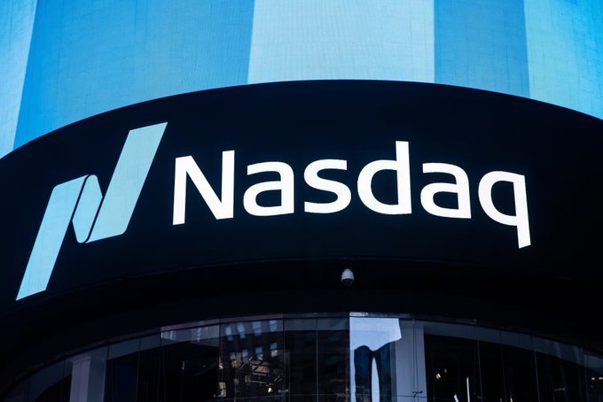 A close-up view of the Nasdaq logo displayed on the exterior of a building, representing the stock exchange's announcement to make its TotalView data feed available on the blockchain via the $PYTH Network.