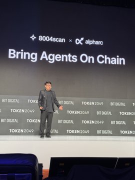 A speaker presents on stage at Token 2049 Singapore, with a large screen behind him displaying "Bring Agents On Chain," the "8004scan × alpharc" logo partnership, and a backdrop patterned with "BIT DIGITAL" and "TOKEN 2049" branding.
