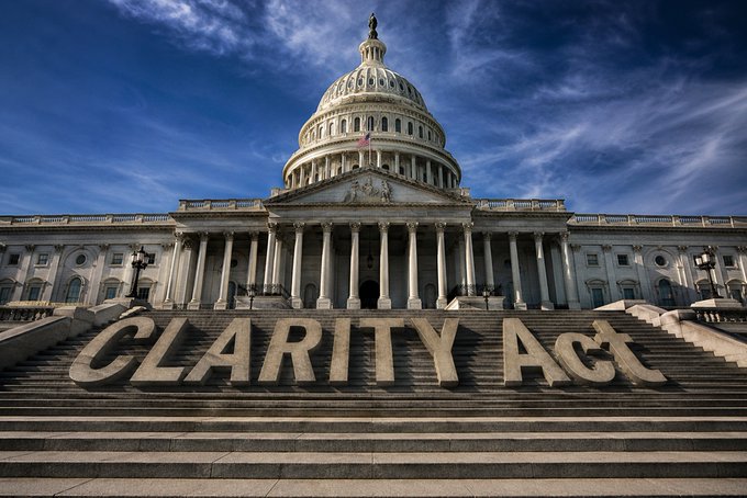 The U.S. Capitol Building with large stone letters spelling "CLARITY Act" placed on the steps in the foreground.