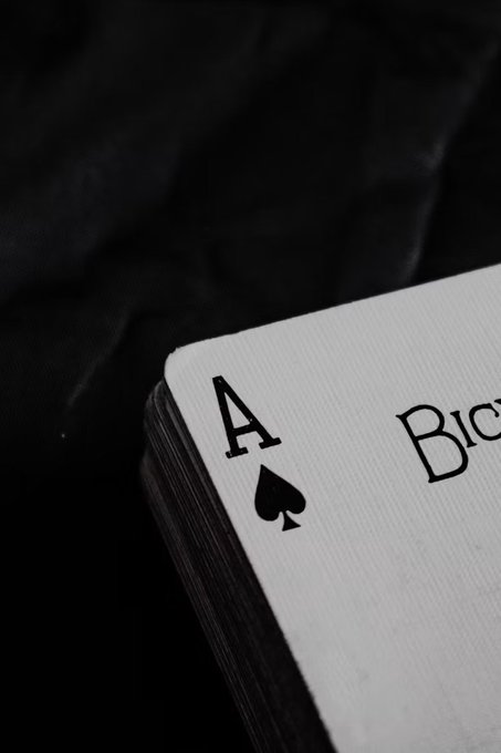 A black-and-white close-up of an Ace of Spades playing card resting on a dark surface. The card's prominent "A" and spade symbol visually reinforce the post's reference to "The Ace" during a volatile NFP trading week.
