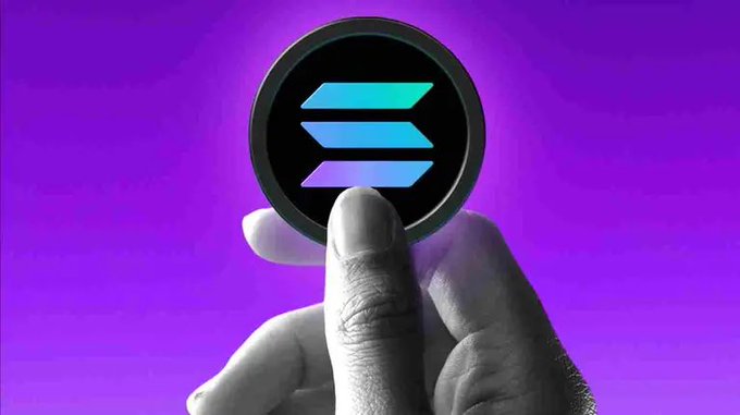 The image features a hand holding up a coin with the "S" logo, which is part of the Ethereum blockchain. Below the coin, there's a caption that reads "Leave your address of Solana". The background of the image is purple, providing a contrast to the white text and the blue and green colors on the coin.