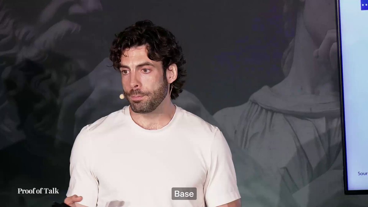 A man in a white t-shirt wearing a headset microphone speaks at the "Proof of Talk" conference, with a "Base" label visible at the bottom of the frame. The image relates to the post as it likely shows Base's Head of Marketing discussing the $1.3 billion contribution of Bitcoin lending to Base's Total Value Locked (TVL).