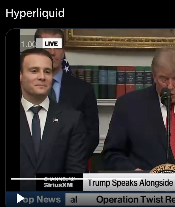 A screenshot of a SiriusXM Channel 121 news broadcast showing President Trump speaking alongside a young man, with the headline "Trump Speaks Alongside" and ticker mentioning "Operation Twist." The "Hyperliquid" watermark and the post's reference to filling long positions on $HYPE suggests the man pictured may be the founder of the Hyperliquid crypto platform, humorously captioned as if smiling knowingly at viewers who just went long before a major announcement.