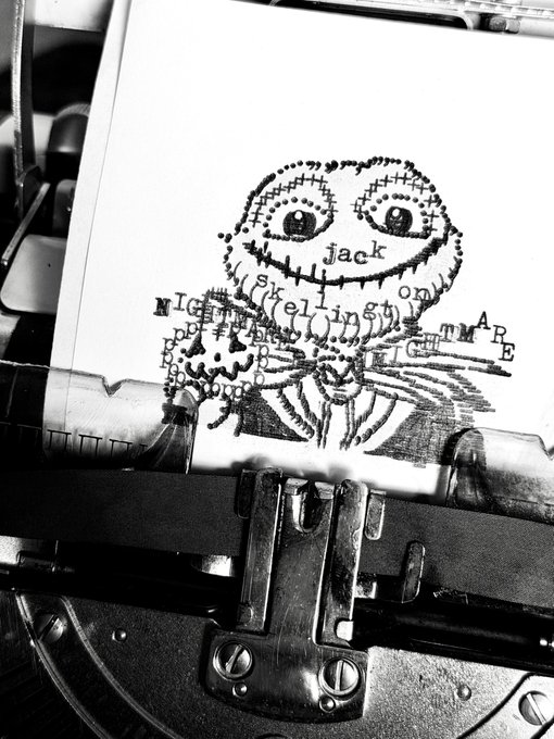 Black-and-white photograph of a vintage typewriter with a piece of paper showing a stitched, Frankenstein-like creature reading 'jack skellington nightmare before christmas'.