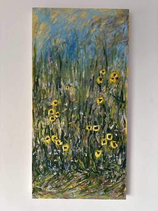 An impressionistic painting of a field of yellow flowers and tall grasses under a blue and yellow sky, mounted on a wall.