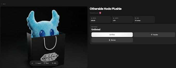 The image shows a blue stuffed animal sitting inside an open black shopping bag against a dark background. The text "I fell asleep and missed With announcement @OthersideMeta out on buying it ( Koda plushie)" suggests that someone has purchased this item, but they have not yet posted about it on social media or their blog.