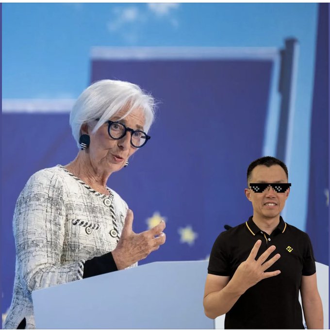 An older woman with white hair and black glasses gestures while speaking at a podium, standing next to a shorter man wearing pixelated sunglasses and a black polo shirt, with an EU flag background.