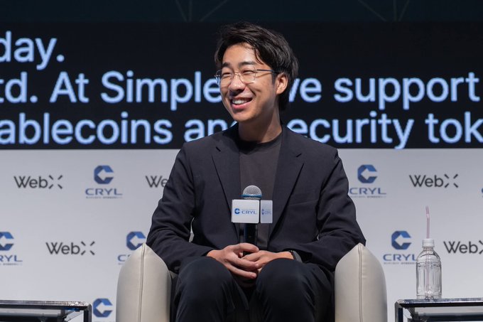 Sota Watanabe, co-founder of JPY Stablecoin, smiles while speaking at the WebX Asia conference, with a backdrop featuring "CRYL" and "WebX" logos and partial text about Simple's support for stablecoins and security tokens.