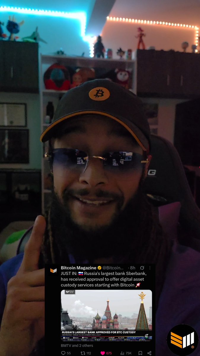 A selfie of a man with dreadlocks wearing a Bitcoin logo cap and sunglasses with screens embedded in the lenses, with a Bitcoin Magazine tweet overlaid reporting: "JUST IN: 🇷🇺 Russia's largest bank Sberbank, has received approval to offer digital asset custody services starting with Bitcoin 🚀"