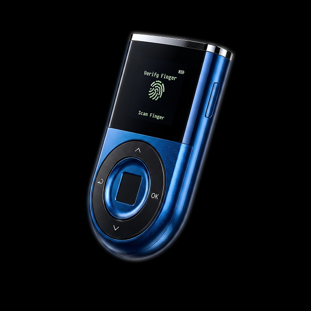 A metallic blue D'CENT hardware wallet is displayed at an angle against a black background, with its screen showing "Verify Finger" and "Scan Finger" prompts above a fingerprint icon, aligning with the post showcasing this crypto storage device to the XRP community.