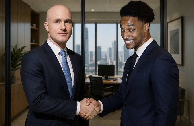 Two businessmen in suits shaking hands in a modern office with a city skyline visible through the windows behind them.