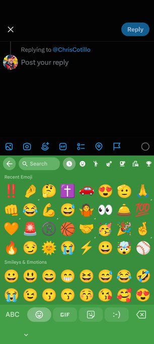 A screenshot of the X (Twitter) mobile app showing the reply composition screen with the emoji keyboard open, replying to user @ChrisCotillo.