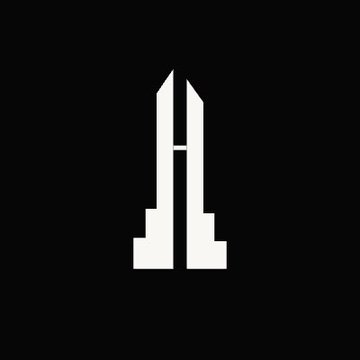 A minimalist white logo featuring a tall, symmetrical emblem with two pointed vertical elements and stepped bases resembling pillars, set against a black background, visually representing the "STANDARD" symbol referenced in the post about the $STANDARD ecosystem and the Standard Reserve on the Robinhood Chain.