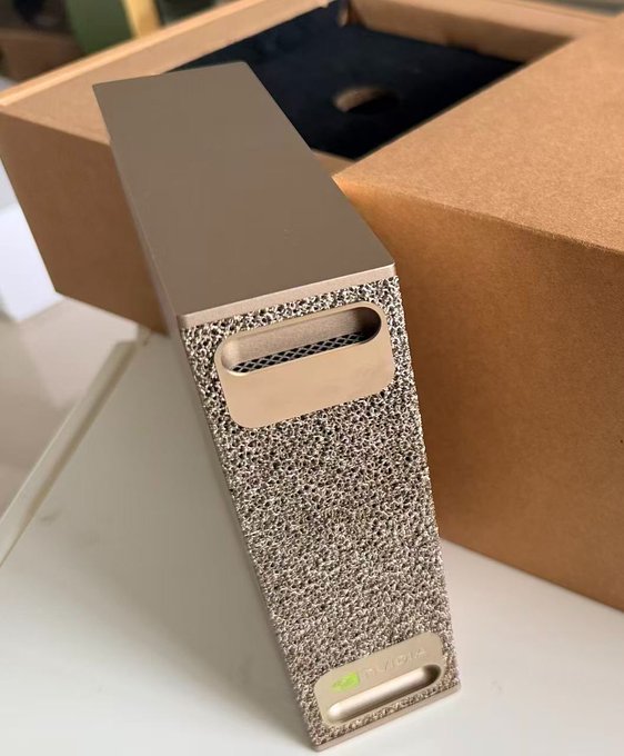A gold-colored textured device, likely a high-performance computer component or server, is shown next to its original box. The name "BLADIA" is visible on the bottom of the device.