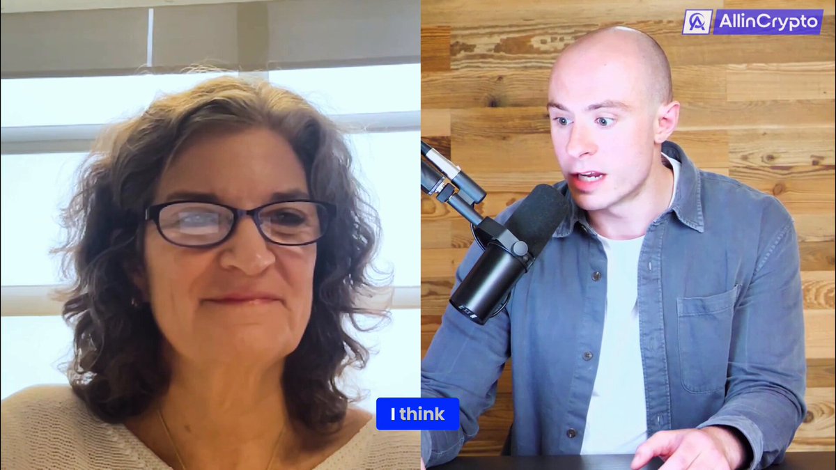 The image shows a woman wearing glasses talking to another person who appears to be bald, both of them holding microphones. The background features a wooden wall, which could be part of an office or studio setting for their conversation. The text on the image reads "Stellar was built from the start for cross-border payments and asset issuance. Today, that same network supports stablecoins, market funds and more." This suggests that they are discussing the capabilities and features of the Stellar blockchain platform.