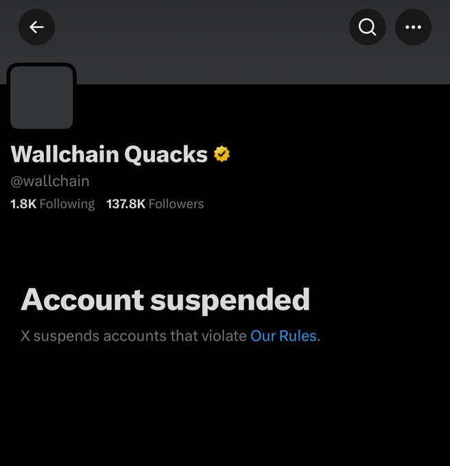 The image shows a black screen with white text, which reads "Account suspended X suspends accounts that violate Our Rules". This message appears to be related to an account or social media post by someone named Wallchain Quacks. The reason for suspension is not explicitly stated in the image, but it seems to be connected to the account's content or behavior.
