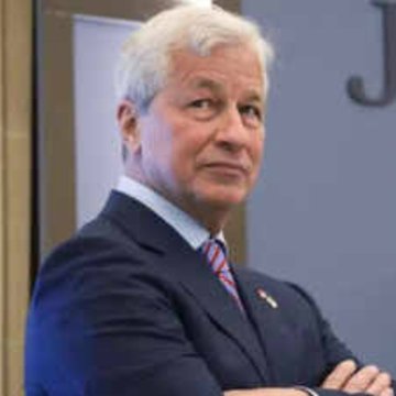 The image shows Jamie Dimon, CEO of JPMorgan Chase, at what appears to be a JPMorgan event (with a "J" logo visible in the background). The post references JPMorgan's expansion of JPM Coin onto Ethereum, tying the image of Dimon to his firm's major move into blockchain-based payment technology.