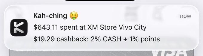 A smartphone notification from an X app reads 'Kah-ching' with a money-mouth emoji, stating '$643.11 spent at XM Store Vivo City' and '$19.29 cashback: 2% CASH + 1% points'.