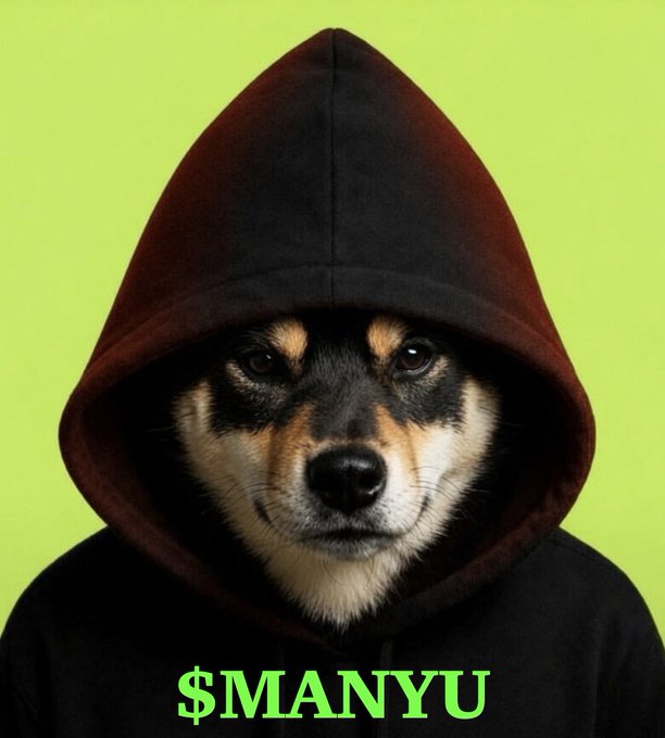 A close-up photo of a Shiba Inu dog wearing a black hood pulled over its head, with '$MANYU' written in green text at the bottom against a lime green background.