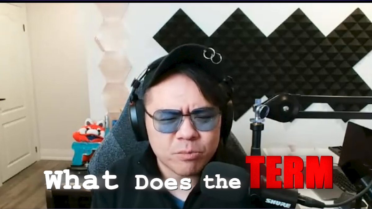 The image shows a man wearing headphones sitting at a desk with a microphone in front of him. The text "What does the term mean?" is displayed above his head, suggesting that he might be discussing or explaining the meaning of the term within the context of the podcast they are hosting.