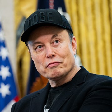 A man wearing a black "DOGE" cap appears in an official setting with American flags in the background, visually tying to the post's theme about Elon Musk and his commentary comparing fiat currency to Bitcoin through the lens of energy.