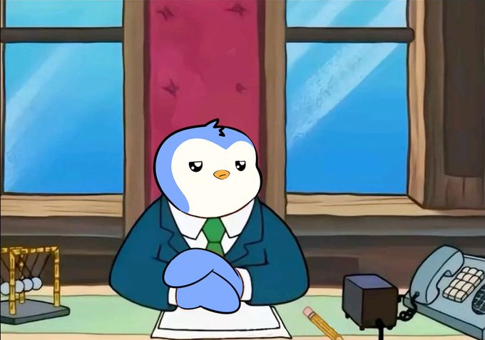 A cartoon penguin character wearing a blue suit and green tie sits at a desk with crossed arms, appearing disgruntled in an animated scene.