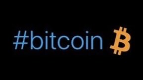 A simple graphic displays the hashtag '#bitcoin' in blue text next to an orange Bitcoin symbol on a black background.