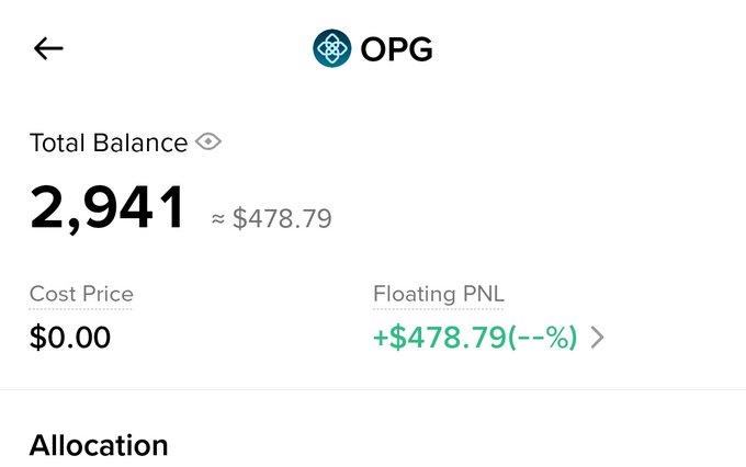 The image features a screenshot of an app that provides information about the total balance, cost-price, and floating price of the cryptocurrency. The post also states that Binance has sent another gift to OPG users. There are three different views displayed in the image based on the perspective it is taken from - the top view being the original screenshot; a closeup shot at the bottom edge with more detail around the center; and an overview shot of the app's interface, showing the user how to navigate and access these features.