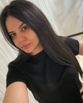The image features a woman with long dark hair wearing a black shirt, standing against a white wall or door frame. The photo appears to be taken by someone who has posted it online, as indicated by the caption "Artist/ Art (Castle'S Beating Heart 0.45 $ETH)". This suggests that the woman might have been inspired by the artist's work and decided to capture her own image with a similar theme or style.