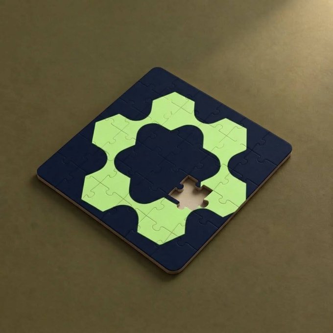 A close-up photograph of a partially completed jigsaw puzzle featuring a four-leaf clover design in light green on a dark blue background.