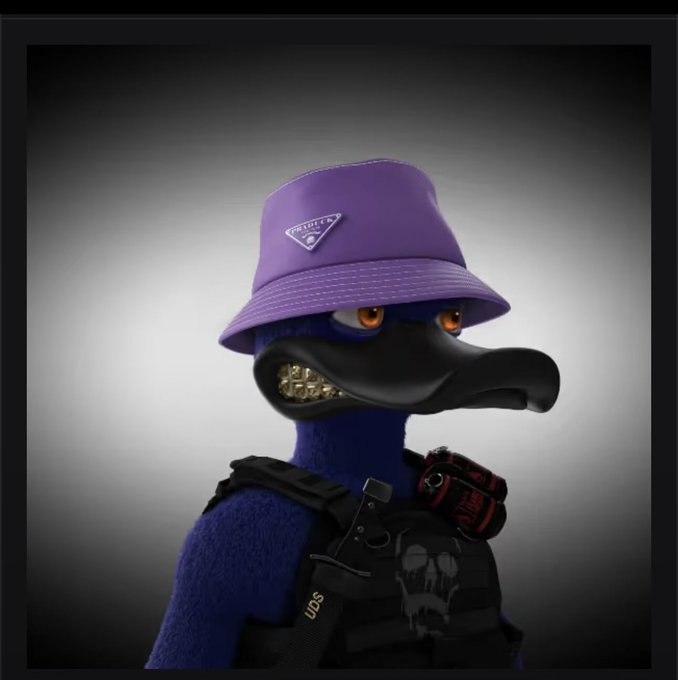 A 3D-rendered blue duck character with a prominent bill, wearing a purple Prada bucket hat, gold grillz, and a tactical black vest labeled "UDS" with a red grenade. The image ties to the post as a newly minted NFT "Duck" from the user's collection, marking their 61st duck minted toward an ongoing goal.